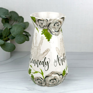 Large vase decorated with gray florals and two children's handprints 