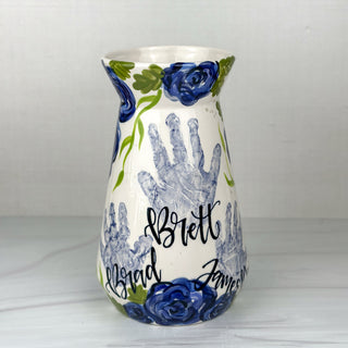 Large vase decorated with blue florals and three children's handprints