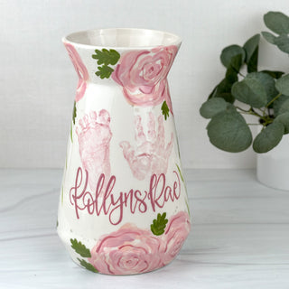 Large vase decorated with pink florals and a child's hand and footprint