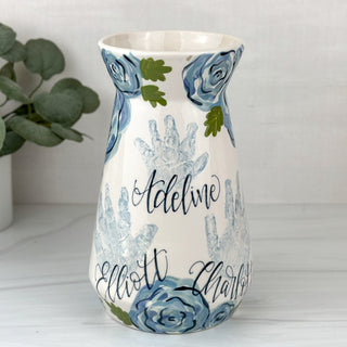 Large vase decorated with blue florals and three children's handprints 
