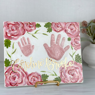 Large tray decorated two impressions of two children's handprints as well as pink florals