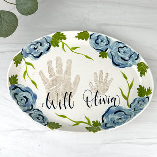 Large platter decorated with blue florals and two handprints 