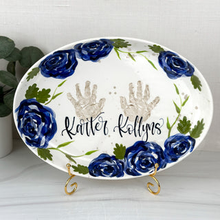 Large platter decorated with dark blue florals and two handprints 