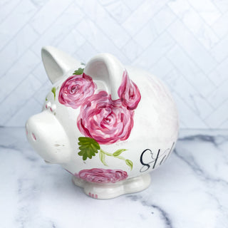 Piggy bank decorated with pink florals.
