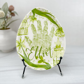 Green easter egg shaped plate made with a child's handprint. 
