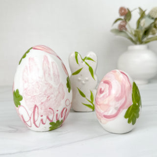 Pink floral eggs and bunny made with a child's handprint. 
