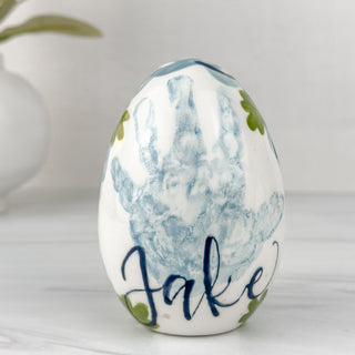 Blue easter egg made with a child's handprint. 