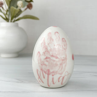 Pink easter egg made with a child's handprint. 