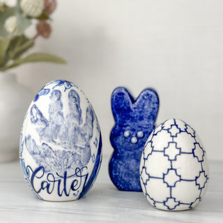 Blue easter eggs and blue bunny with a child's handprint. 