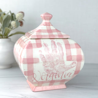 Pink gingham jar with handprint.