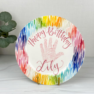 Rainbow lined "Happy Birthday" plate made with a child's handprint. 