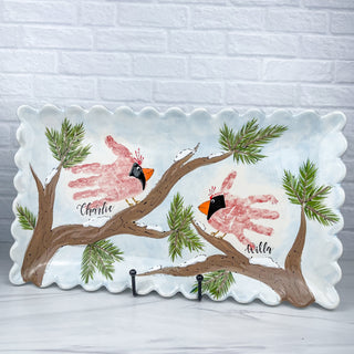 Large plate decorated with two cardinals made from children's handprints 