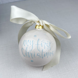 Round ornament decorated with "My First Christmas"