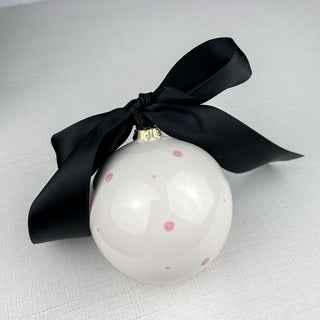Round ornament decorated with pink polka dots