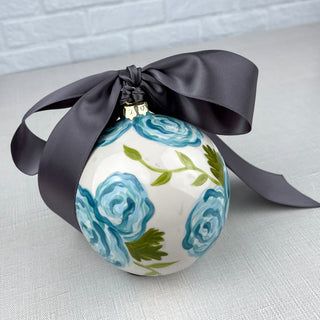 Round ornament decorated with blue florals and greenery