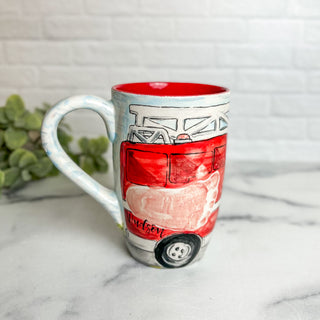 Coffee mug with a red fire truck made with a child's footprint.