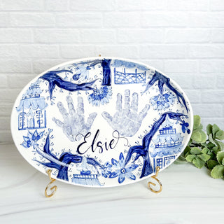 Large platter decorated with chinoiserie artwork and a child's handprints. 
