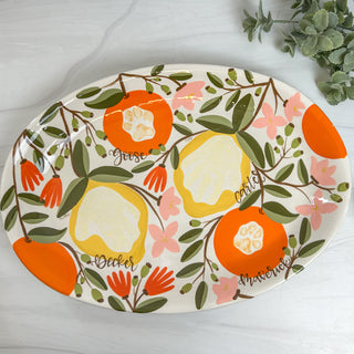 Large platter decorated with fruit art made with two paw prints and two handprints.