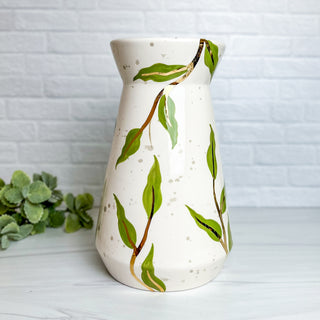 Large vase decorated with greenery.