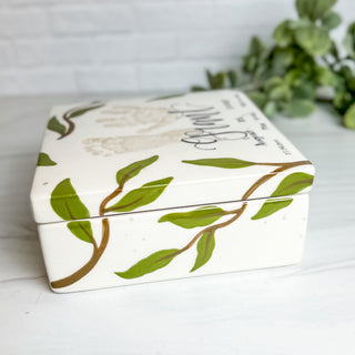Side view of box decorated with greenery artwork.
