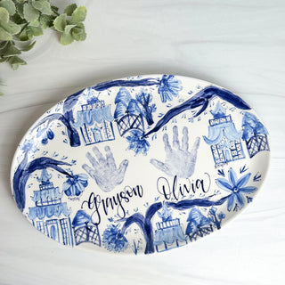 Large platter decorated with chinoiserie and two children's handprints. 
